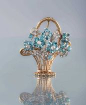 A TOPAZ AND DIAMOND FLOWER BASKET BROOCH, the six claw set blue topaz flower heads all centred by