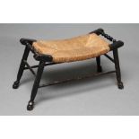 AN ARTS AND CRAFTS EBONISED RUSH SEATED STOOL, late 19th century, the oblong dished seat with