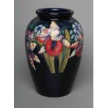 A MOORCROFT POTTERY ORCHID PATTERN VASE, mid 20th century, of ovoid form, tubelined and painted in