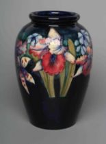 A MOORCROFT POTTERY ORCHID PATTERN VASE, mid 20th century, of ovoid form, tubelined and painted in