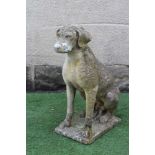 A CAST STONE FIGURE OF A SEATED DOG on an oblong plinth, 18" x 27 1/4" (Est. plus 24% premium inc.