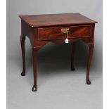 A GEORGIAN MAHOGANY SIDE TABLE, mid 18th century, the moulded edged rounded oblong top over waved