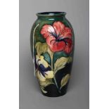 A MOORCROFT POTTERY HIBISCUS PATTERN VASE, mid 20th century, of rounded cylindrical form,