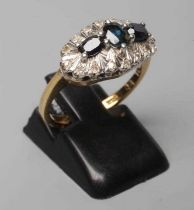 A SAPPHIRE AND DIAMOND DRESS RING, the three oval facet cut sapphires point set to a white mount