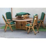 AN ARTS & CRAFTS STYLE SLATTED TEAK DINING SUITE, the circular table on concave sided square base,