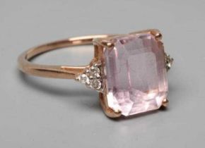 A KUNZITE AND DIAMOND DRESS RING, the oblong cut Kunzite claw set and with three small round