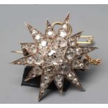 A VICTORIAN DIAMOND STAR BROOCH/PENDANT, the central old cut stone of approximately 0.50cts to an