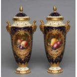 A PAIR OF COALPORT CHINA VASES AND COVERS, c.1900, of slender ovoid form with ram's mask handles,