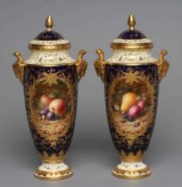 A PAIR OF COALPORT CHINA VASES AND COVERS, c.1900, of slender ovoid form with ram's mask handles,