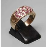 A RUBY AND DIAMOND DRESS RING, the oval panel point set with numerous small diamonds and rubies to a