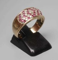 A RUBY AND DIAMOND DRESS RING, the oval panel point set with numerous small diamonds and rubies to a