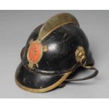 AN AUSTRIAN FIREMAN'S LEATHER HELMET with brass crest, badge, lion head bosses and leather chin