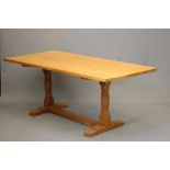 DAVID LANGSTAFF, AN ADZED OAK DINING TABLE, the rounded oblong top on turned faceted end supports,