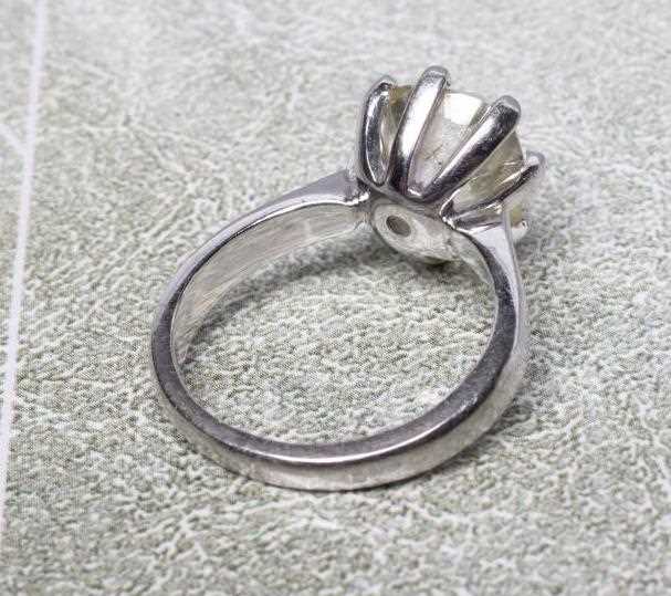 A SOLITAIRE DIAMOND RING, the cushion cut stone of 5.19cts, claw set to a plain platinum shank, size - Image 4 of 8