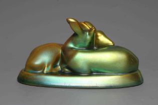 A ZSOLNAY PECS GREEN IRIDESCENT POTTERY MODEL, mid 20th century, of two recumbent deer, printed gilt