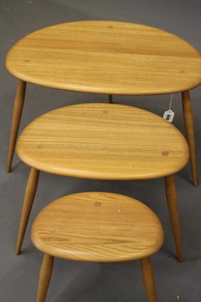 A NEST OF ERCOL MODEL 354 ELM "PEBBLE" TABLES, raised on turned beech supports, largest 25 3/4" x 17 - Image 2 of 2