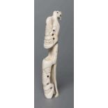 A CARVED INUIT TOTEM, made of polar bear bone, from Kulusuk-Kap Dam, Greenland, with three faces and