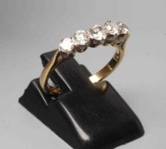 A FIVE STONE DIAMOND RING, the round brilliant cut stones point set to a plain 14ct gold shank,