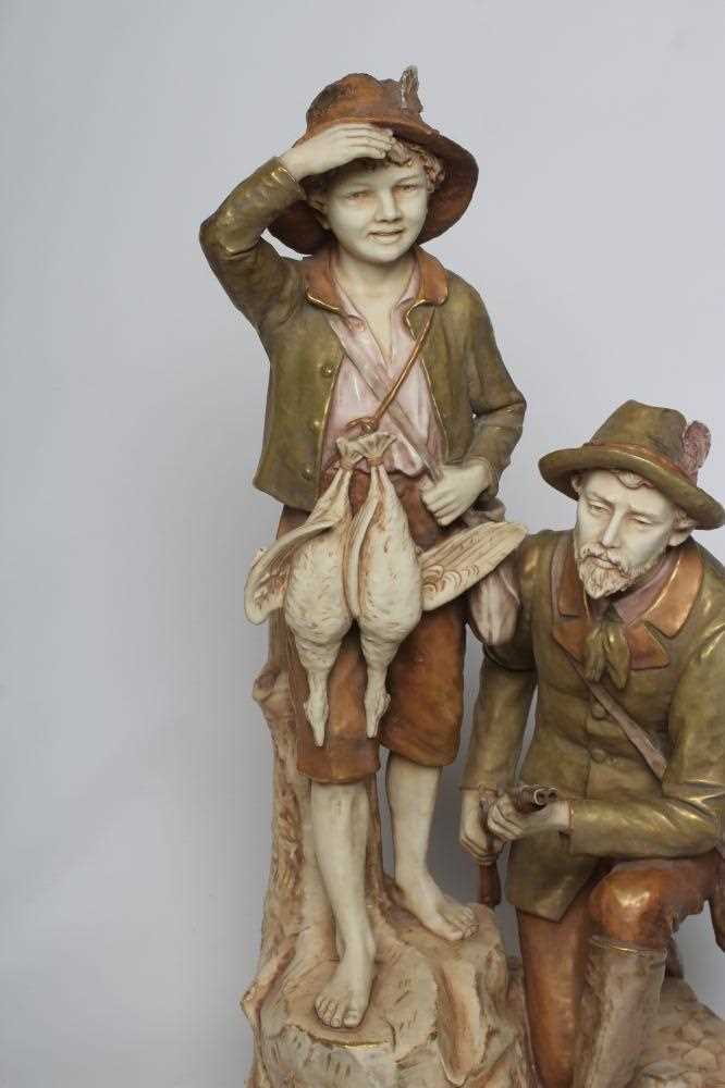 A ROYAL DUX BISQUE PORCELAIN FIGURE GROUP, early 20th century, modelled as a father holding a double - Image 2 of 5