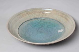 Y JOHN DUNN (b.1944) - a large Raku iridescent turquoise glazed stoneware circular dish, signed, 22"