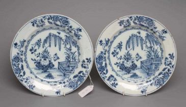 A PAIR OF ENGLISH DELFT PLATES, probably Liverpool c.1760, painted in blue with a fence, weeping