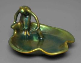 A ZSOLNAY PECS GREEN IRIDESCENT POTTERY FIGURAL DISH, mid 20th century, modelled as a scantily