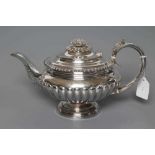 A GEORGE IV SILVER TEAPOT, maker Charles Fox, London 1824, of squat semi lobed baluster form with