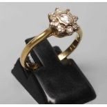 A NINE STONE DIAMOND CLUSTER RING, the round brilliant cut stones point set to a plain 18ct gold