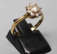 A NINE STONE DIAMOND CLUSTER RING, the round brilliant cut stones point set to a plain 18ct gold