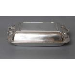 A SMALL SILVER ENTREE DISH AND COVER, maker Mappin & Webb, Sheffield 1935, of plain rounded oblong