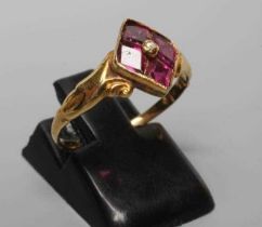 A VICTORIAN ALMANDINE GARNET RING, the lozenge panel set with four stones centred by a bead, to