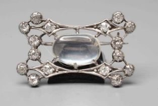 AN EDWARDIAN DIAMOND AND MOONSTONE BROOCH, the open concave oblong panel centred by a claw set