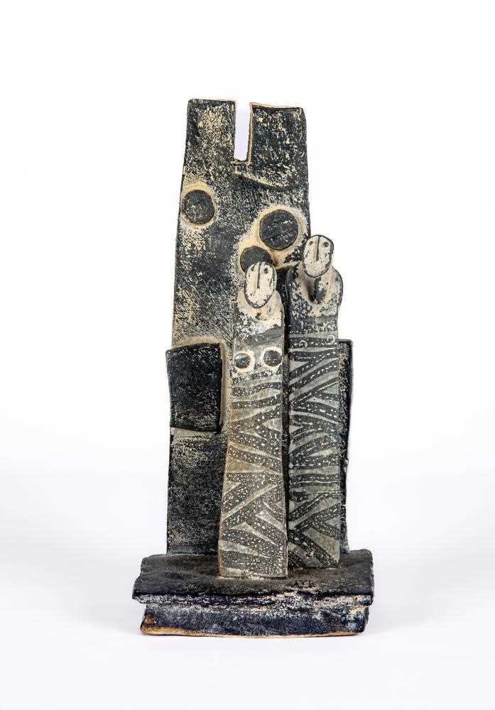 Y JOHN MALTBY (1936-2000) - a matt grey stoneware sculpture of two figures standing before a cut