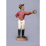 AN AMERICAN(?) CAST IRON AND POLYCHROME "LAWN JOCKEY", early 20th century, modelled standing wearing