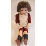 A Heubach bisque socket head boy doll, with blue glass sleeping eyes, open mouth, teeth, wood and