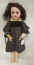 An SFBJ bisque socket head doll, with brown glass sleeping eyes, open mouth, teeth, brown wig,