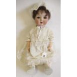 A Gebruder Heubach bisque socket head doll, with brown glass sleeping eyes, open mouth, brown wig,