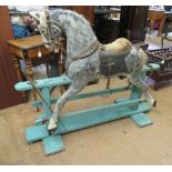 A Victorian rocking horse, of carved wood construction, with mild head tilt, glass eyes, later