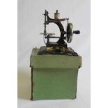 Miniature hand operated sewing machine with cast iron base marked Made in Germany, box AF, G-E (Est.