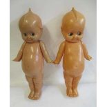 A pair of large celluloid Kewpie dolls, with sideways glancing eyes and jointed shoulders, 21"