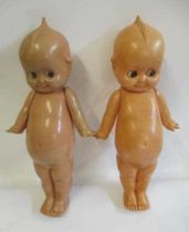 A pair of large celluloid Kewpie dolls, with sideways glancing eyes and jointed shoulders, 21"