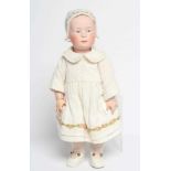 A Gebruder Heubach solemn girl doll, with bisque socket head, moulded and painted eyes, facial