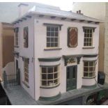 An apothecary shop dolls house, with lazy susan style rotating base and three seperate hinged