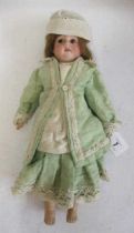 An Armand Marseille bisque shoulder head doll, with brown glass fixed eyes, open mouth, teeth,