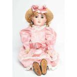A Bebe Jumeau bisque socket head doll, with brown glass fixed eyes, open mouth, teeth, pierced ears,