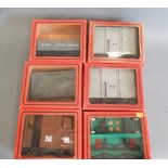 Six Mamod railway wagons comprising two open trucks, two covered vans, wagon kit and brake van,