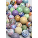 Fifty two early glass and clay marbles from 10-15mm sizes, most items in good condition (Est. plus