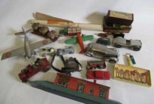 Tinplate toys comprising aircraft, cars, railway station and Dinky road traffic signs, some