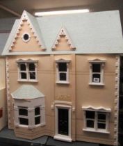 A Victorian style "Dolls House Emporium" dolls house, with two hinged openings revealing seven