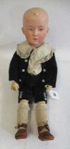 A Heubach solemn boy doll, with moulded eyes, painted features, moulded hair, wood and composition